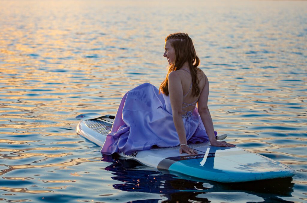 teen wearing a gown on paddle board, sunset teen portrait